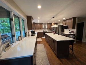 Renovated kitchen with view to deck, natural cabinets, and large island