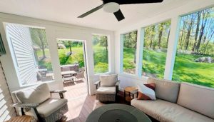 3 season furnished room with lots of big windows and ceiling fan