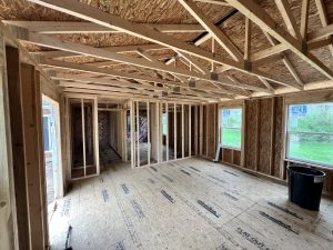 inside of a home addition frame with windows no drywall