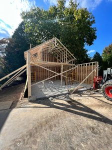 Two-story addition framing with gable roof trusses and slab